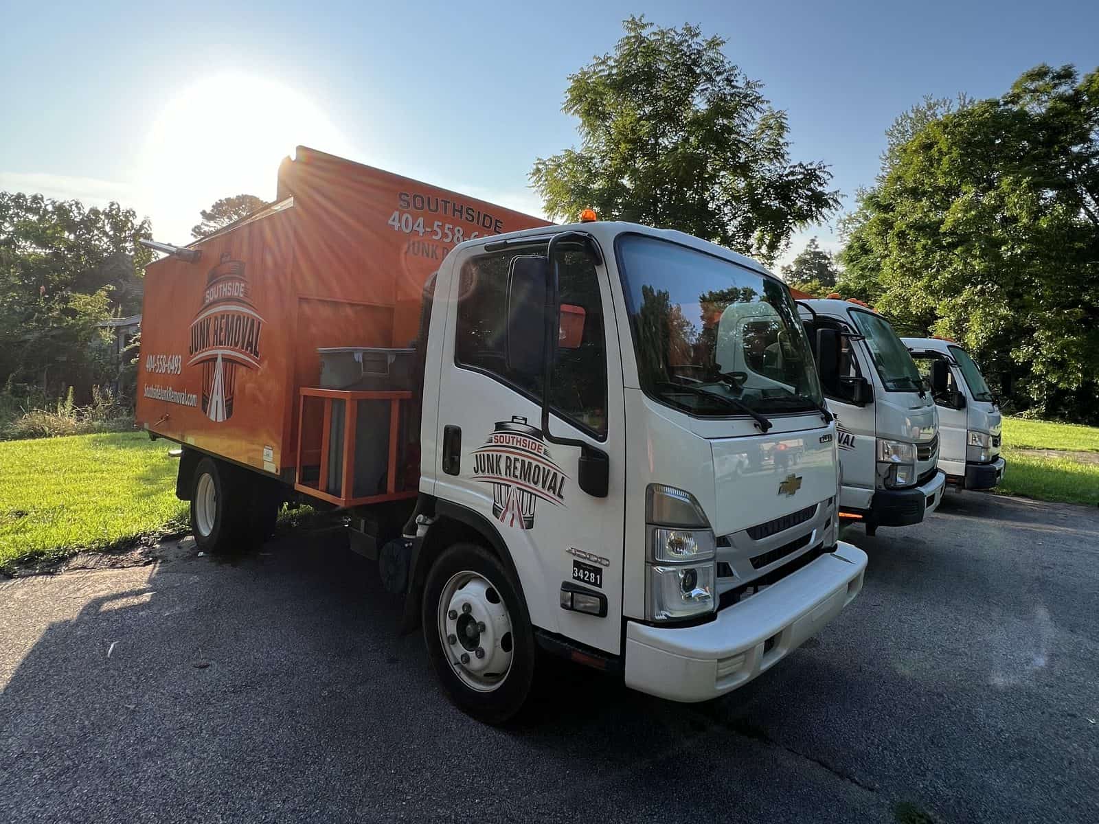 Row of Southside junk trucks parked in a lot in Stockbridge