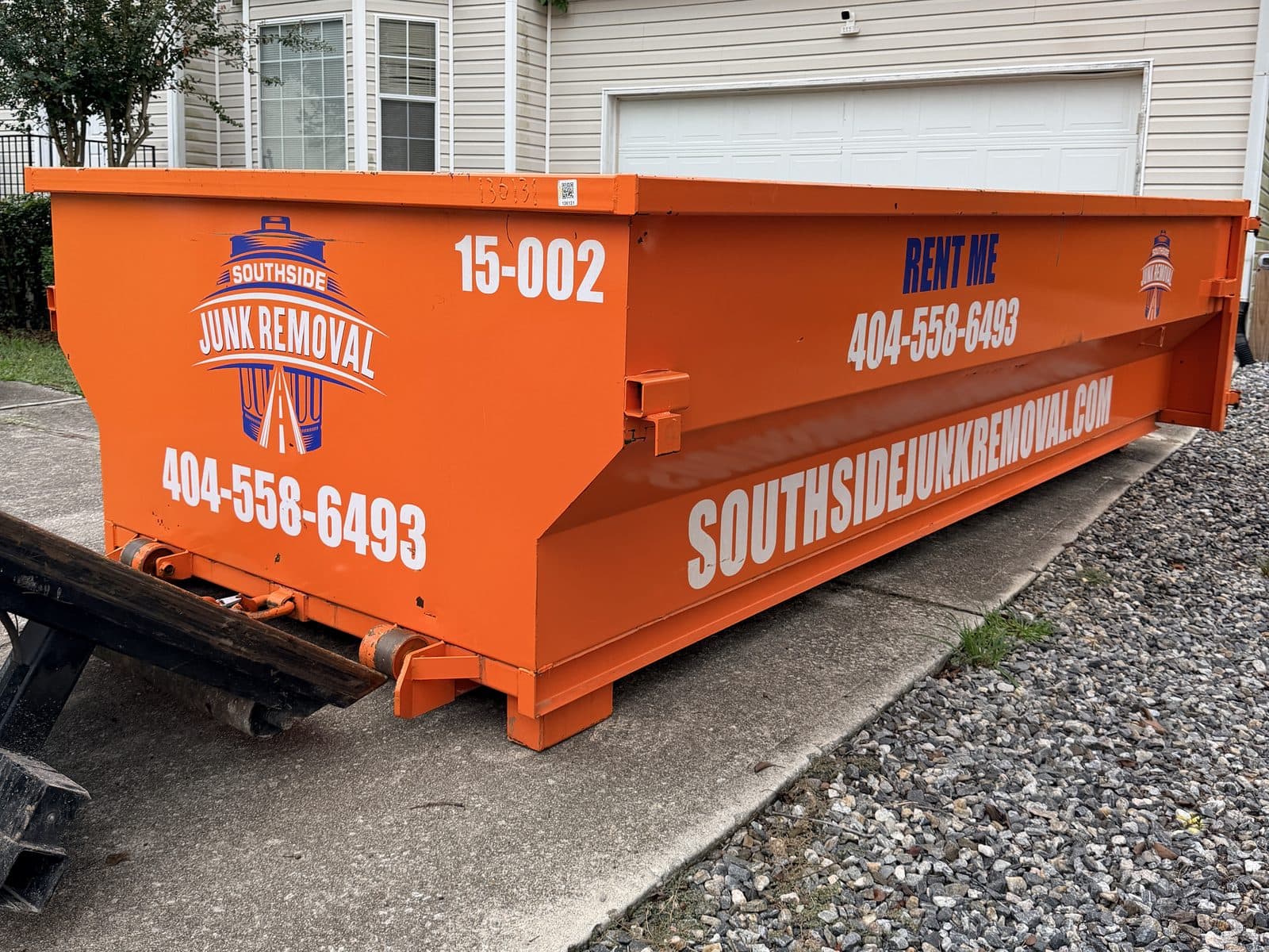 Orange 15-yard Southside dumpster (unit 15-002) sitting in a home driveway