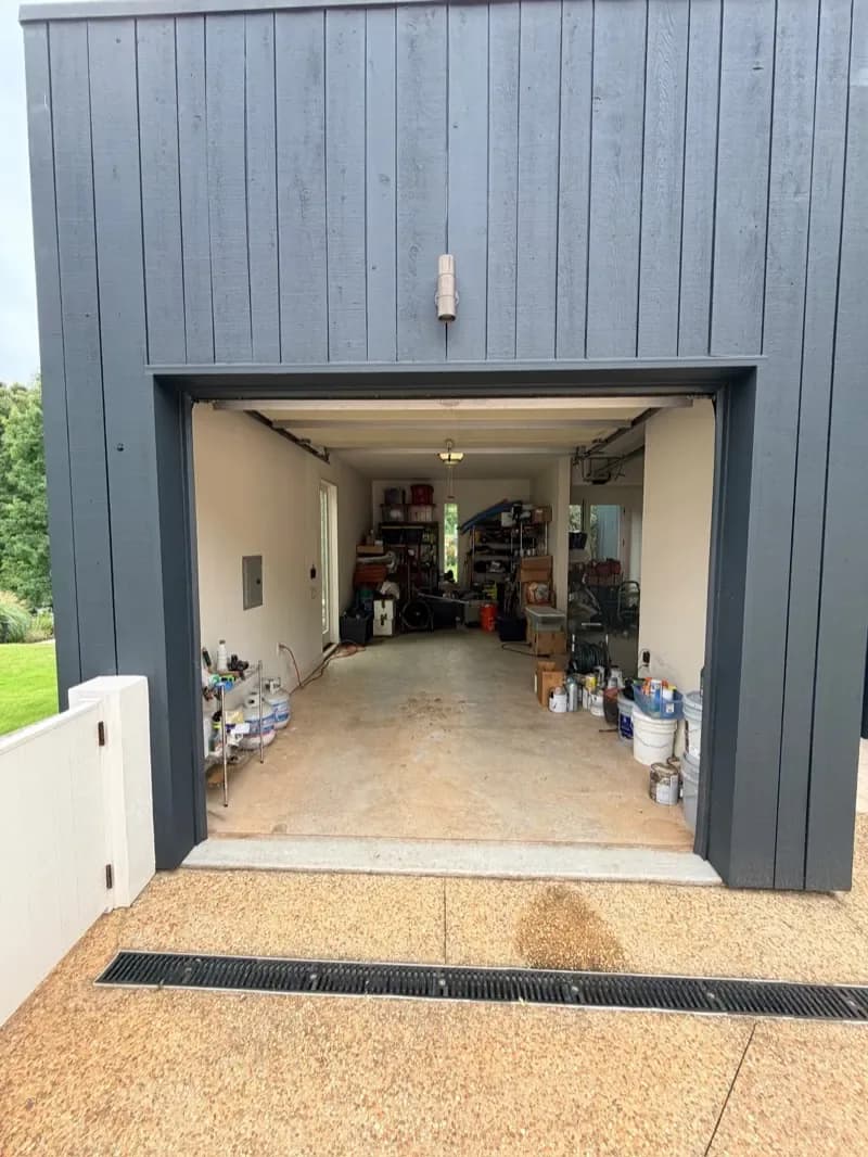The same garage empty and swept after the cleanout