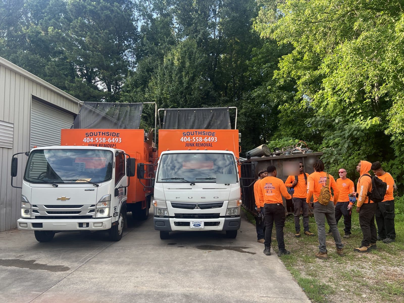 The Southside crew gathered beside two Southside trucks before a job