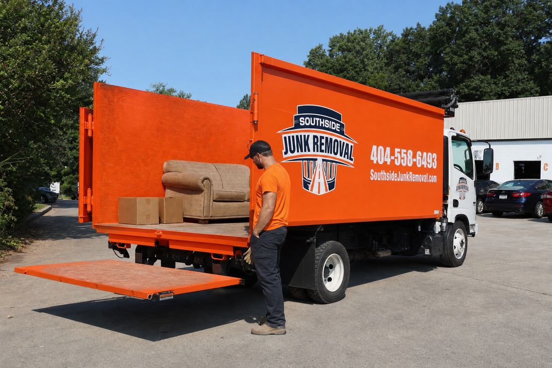 A small junk removal load of one couch and a few boxes sitting in the mostly empty Southside Junk Removal dump truck