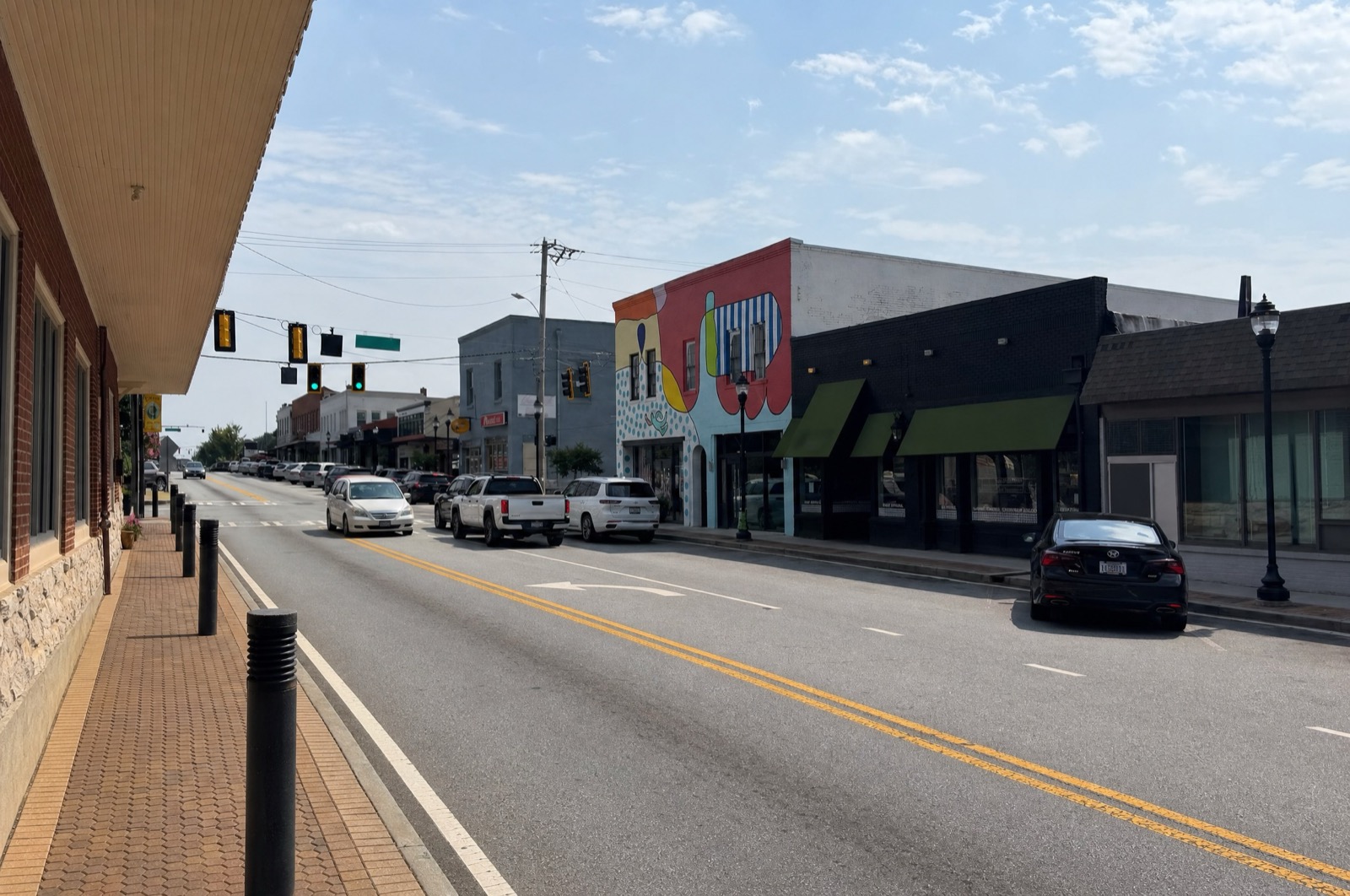 Storefronts and a colorful mural in downtown College Park, GA