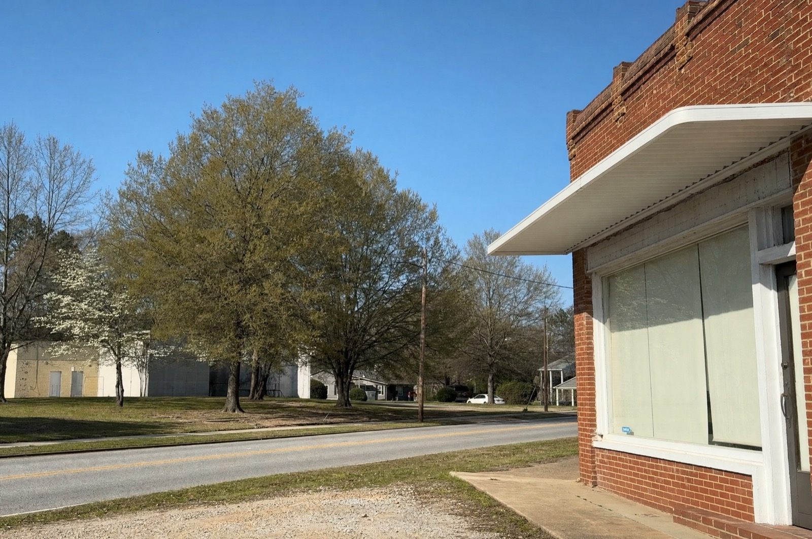 Brick storefront on a quiet tree-lined road, Lovejoy, GA