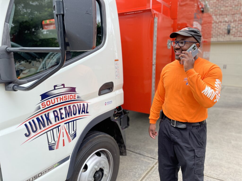 Junk removal professional on the phone scheduling an eviction cleanout appointment