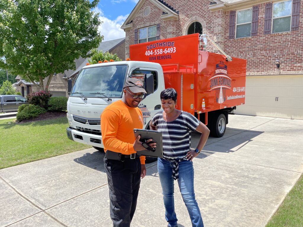 Junk removal professional explainign the process and cost of dumpster rentals in metro atlanta